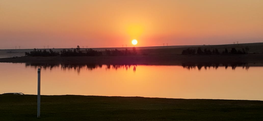 Golden sunset reflected across the water at Oranjeville Holiday Resort